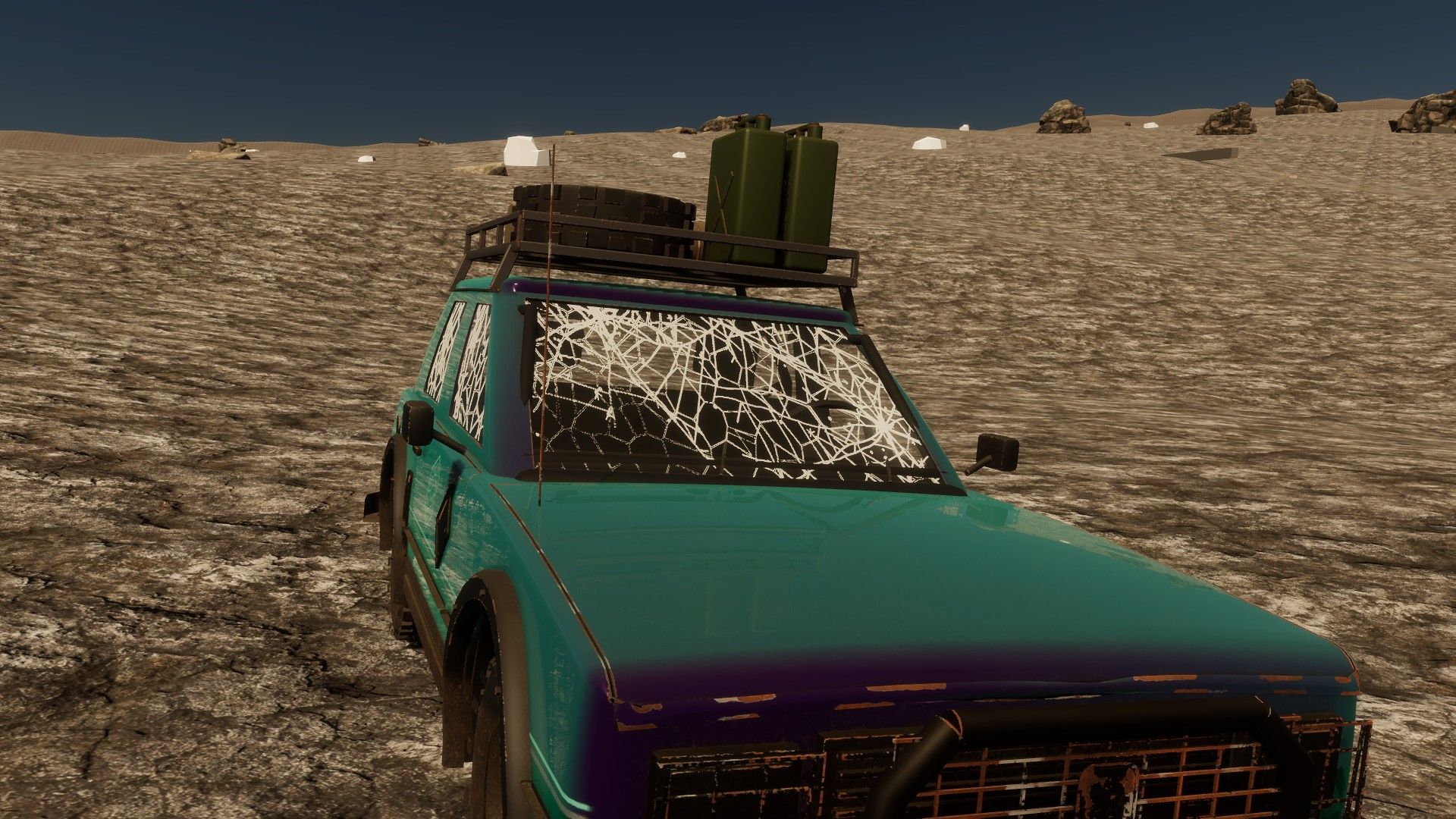A teal hatchback with a spiderweb-cracked windscreen on dry, cracked ground